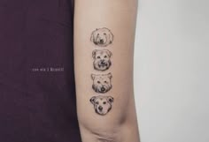 a woman's arm with three dogs on it