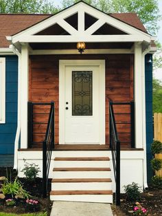 a blue house with white trim and wooden steps