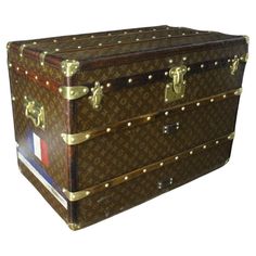 the trunk is brown with gold rivets on it's sides and handles