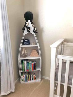 a baby's room with a book shelf and crib in the corner that has books on it