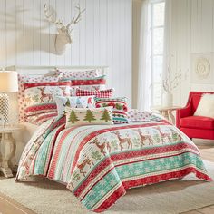 a bed covered in christmas themed comforters and pillows