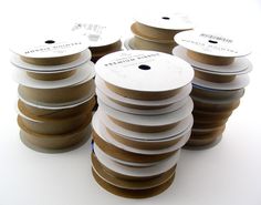 several spools of brown and white tape stacked on top of each other