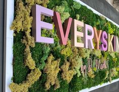 a green wall with the words everyskin on it