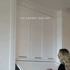 a woman standing in front of cabinets with the words cabinet gallery above her and below her