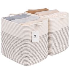 two large baskets with labels on them sitting side by side, one is white and the other is beige