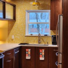 a yellow mosaic tile wall with dark cupboards and clean lines in a new kitchen remodel. Modwalls Mediterranean Porcelain Mosaic Tile | Tangier Yellow | Colorful Modern & Midcentury tile for bathrooms, kitchens, backsplashes, showers, floors, pools & outdoors. Midcentury Kitchen Remodel, Mediterranean Mosaic Tile, Mediterranean Mosaic, Showers Outdoor, Midcentury Style, Kitchen Backsplashes, Wall Opening, Porcelain Mosaic Tile, Tangier