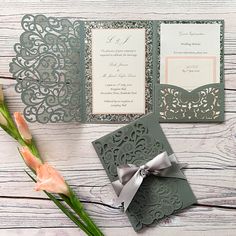 the wedding stationery is laid out on a wooden table