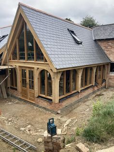 a house being built with wooden framing and slate roof