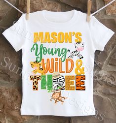 a white shirt with the words mason's young wild and fine on it hanging from a clothes line