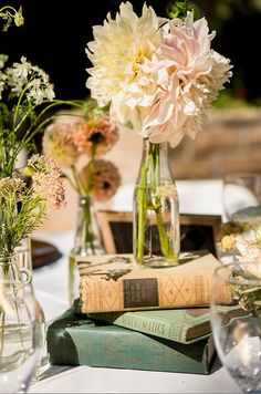 flowers in vases and books on a table