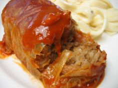 meatloaf with sauce and noodles on a white plate