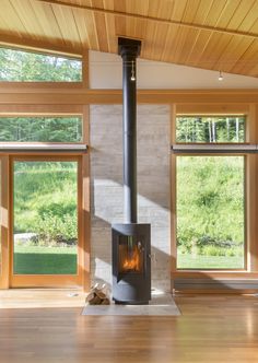 a living room filled with furniture and a fire place in the middle of a room