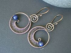 This unique hoop earrings are made with copper wire, shapped and wrapped by hand. The beads I use for these earrings are lapis lazuli, if you desire other stone color just convo me and I make a pair of earrings just for you. They measure between 5.3 cm (2.1 in) and 4.8 cm (1.9) depending on the closure you choose. ##Note: All of my items are 100% handmade. Each piece is made in the design shown but, will have slight variations, they are made one at a time and there so, unique. ### Items ready to Blue Copper Wire Wrapped Earrings, Blue Wire Wrapped Copper Earrings, Blue Copper Wire Earrings With Ear Wire, Unique Hoop Earrings, Lapis Lazuli Earrings, Wire Wrapped Earrings, Copper Wire, Long Earrings, Lapis Lazuli