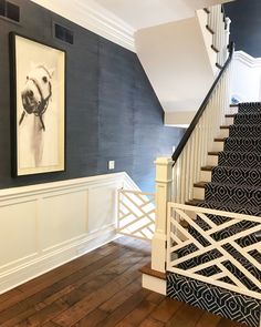 the stairs are painted blue and white with an art work hanging on the wall above them