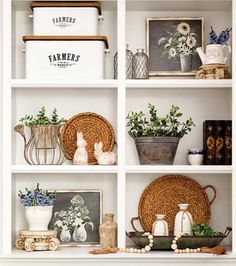 a white shelf filled with vases and other decorative items on top of it's shelves