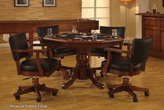 a round table with chairs around it in the middle of a wooden floored room