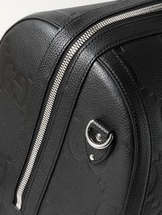 Gucci's duffle bag has been crafted in Italy from monogrammed full-grain leather and can be locked for peace of mind while travelling. It opens wide for easy access to your belongings and comes with a detachable shoulder strap. Get the matching briefcase to look polished on business trips. Luxury Satchel Travel Bag With Zipper Closure, Luxury Satchel Travel Bag With Zipper, Luxury Travel Shoulder Bag With Silver-tone Hardware, Designer Leather Travel Bag With Zipper Closure, Designer Leather Travel Bag With Zipper, Luxury Shoulder Bag With Silver-tone Hardware For Travel, Luxury Textured Leather Travel Bag For Formal Occasions, Modern Gucci Bags With Zipper Closure, Luxury Top Handle Duffle Bag With Zipper Closure