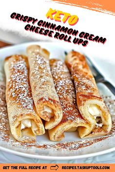 crepy cinnamon cream cheese roll ups on a white plate with powdered sugar