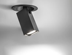 a black square light hanging from the ceiling