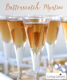 four glasses filled with champagne sitting on top of a counter next to a sign that says butterstetch martini