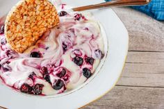 a bowl filled with yogurt and blueberries