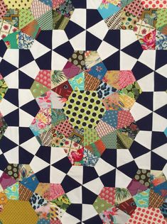 an image of a patchwork quilt made with many different colors and patterns on it