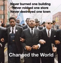 a group of men in suits and ties walking down the street with words that read, never burned one building never robbeded one store never destroyed one town