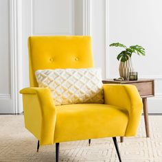 a yellow chair with a white pillow on it