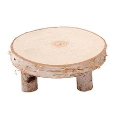 a small wooden stool sitting on top of a white floor next to a tree stump