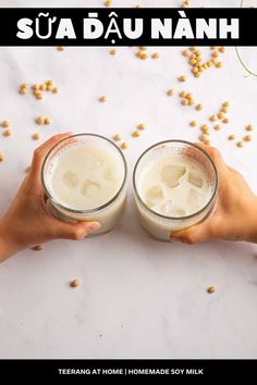 two hands holding glasses filled with milk and cereal