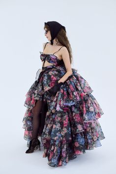 Embody the capricious spirit of Shakespeare's trickster fairy in this two-piece ensemble. A slinky slip dress with a coquettish bow-tied bust meets a voluminous tiered skirt, with an extra-long satin ribbon closure. Scattered blooms dance across the inky canvas, echoing the mischievous footsteps of A Midsummer Night’s beloved Puck. This is a two piece set. Two piece slip dress set with tiered maxi skirt Slip dress features a peek-a-boo cutout and underwire cups with a ribbon bow tie at bust Incl Trickster Fairy, Skirt Slip, Silk Dressing Gown, Ruffle Maxi Skirt, Corset Skirt, Puff Dress, Tiered Maxi Skirt, Knitted Coat, Dress Set