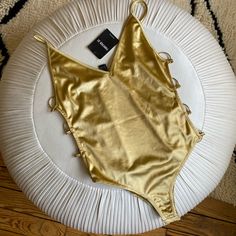 Forever 21 Nwt Golden Metallic One-Piece Size Small Brand New With Tags Honestly Can’t Tell If It’s Supposed To Be A Swimsuit Or Bodysuit But It Could Maybe Be Either! Snaps On The Bottom. So Stunning And Feels Like Surprisingly Good Quality For Forever21 I Bought This A Few Years Ago But Have Never Worn, So It’s Definitely Rare/Sold Out. Very Cool Ring Details That Go Down The Sides. #Carriebradshaw #Y2k #Charliesangels Gold Fitted Bodysuit For Beachwear, Gold Bodysuit For Night Out, Gold Party Bodysuit With Lined Body, Gold One-piece Bodysuit For Beachwear, Gold Stretch Bodysuit For Summer, Trendy Bodysuit For Night Out At Beach Season, Trendy Bodysuit For Night Out During Beach Season, Trendy Bodysuit For Night Out And Beach Season, Forever 21 Chic Bodysuit For Party