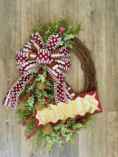 a football wreath with the word gon's is hanging on a wooden floor