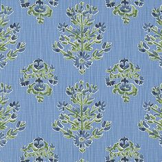 a blue and green floral pattern on fabric