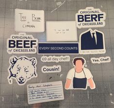 various stickers on the ground with writing and pictures attached to them, including an image of a man in a suit