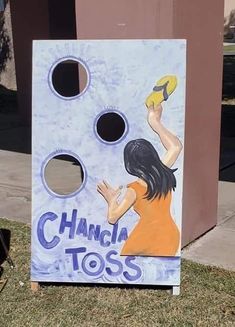 a painted cornhole game with a woman holding a frisbee in her hand