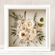 a white frame with some flowers in it