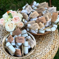 two baskets filled with thank you tags and flowers on top of each other in the grass