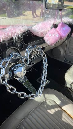 the interior of a car with a heart shaped key chain hanging from it's center console