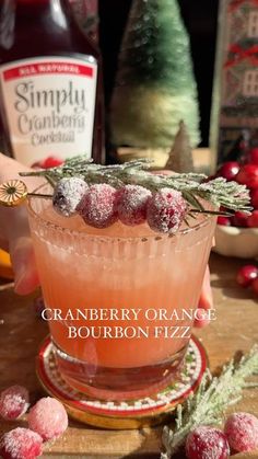 the cranberry orange bourbon fizz is garnished with powdered sugar