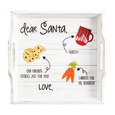 a wooden tray with some food on it and words written in different languages that say dear santa, our favorite cookies just for you love