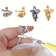 someone is holding three different rings in their hand and they are all made out of yarn