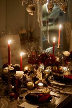 a table with candles and skulls on it