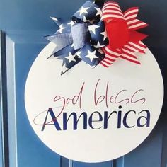 a patriotic door hanger that says god places america