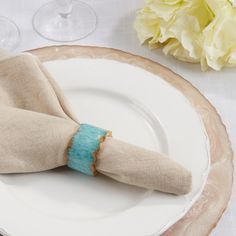 the napkin is wrapped in burlap paper and placed on top of a plate