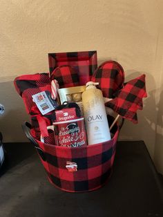 a red and black plaid basket filled with personal care items on top of a table