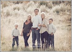 a family posing for a photo in a field