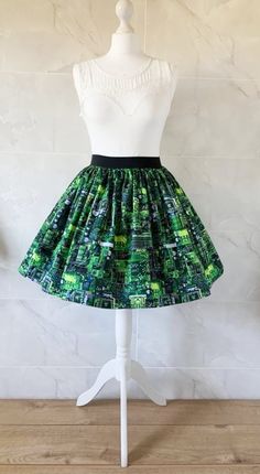 Circuti Board Skirt Gathered  full skirt made from a beautiful 100% cotton,  Circuit Board fabric. Each skirt is made by gathering the fabric onto  a 2 inch black elastic waistband. The length measures from the top of the waistband and comes in three lengths, 19", 22" or 25". Please choose length from the drop down menu. The waist measurement can be seen in the measurement guide below. Please choose waist size from the drop down menu. The skirt is pictured with a petticoat to show its potential Green Cotton Midi Skirt, Green Pleated Full Skirt, Casual Green Full Skirt, Stretch Cotton Mini Skirt For Party, Green Pleated Tiered Mini Skirt, Green Full Skirt With Lining, Party Pleated Cotton Skirt, Green Pleated Party Skort, Cotton Party Skort