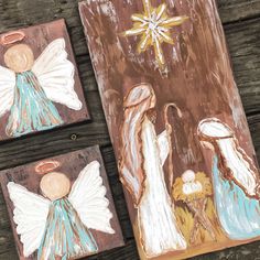 three paintings of the birth of jesus on wooden planks with star and snowflake