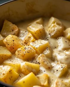 potatoes and cream in a skillet with seasoning on the top, ready to be eaten